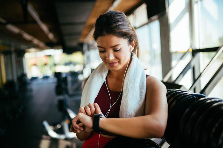 Athletic woman checking the time on wristwatch